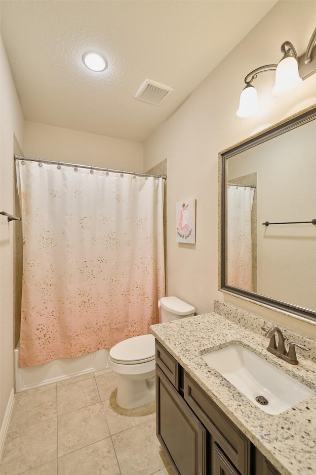 bathroom featuring tile patterned flooring, visible vents, toilet, vanity, and a textured ceiling