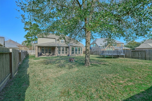 view of yard featuring a fenced backyard and a trampoline