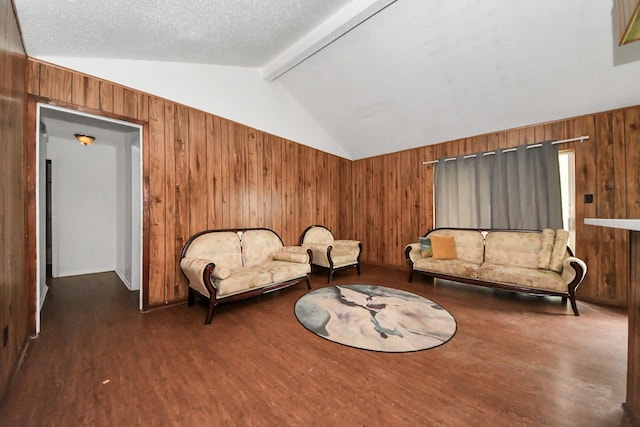 interior space with a textured ceiling, dark hardwood / wood-style floors, wood walls, and vaulted ceiling with beams