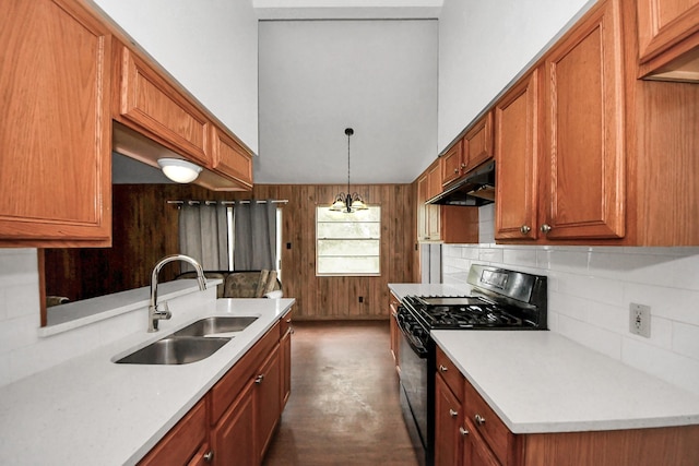 kitchen featuring decorative light fixtures, sink, black gas range oven, and tasteful backsplash