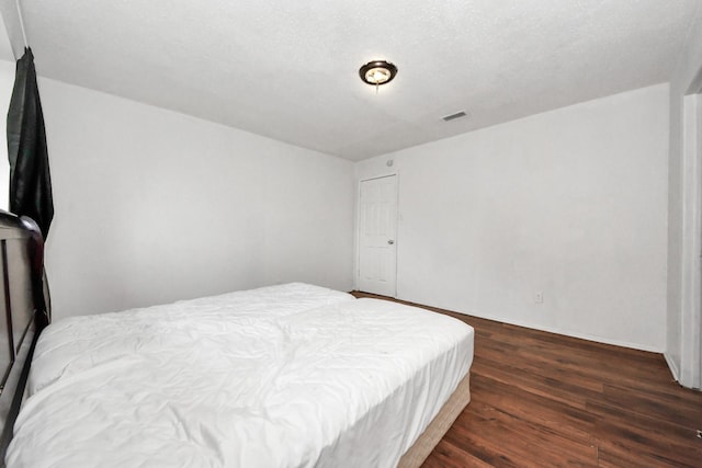 bedroom featuring dark wood-type flooring