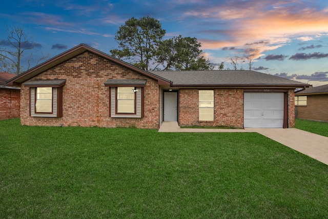 single story home with a garage and a lawn