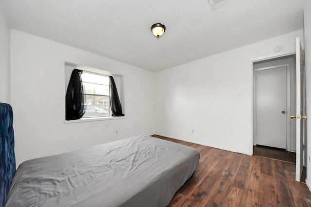 bedroom featuring dark hardwood / wood-style floors