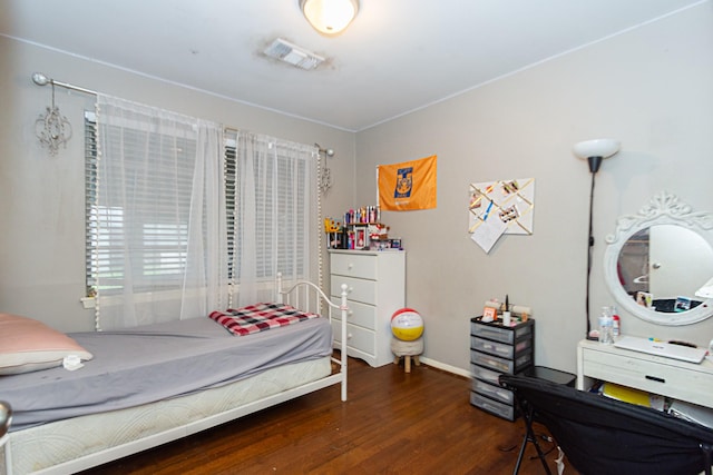 bedroom with dark hardwood / wood-style flooring