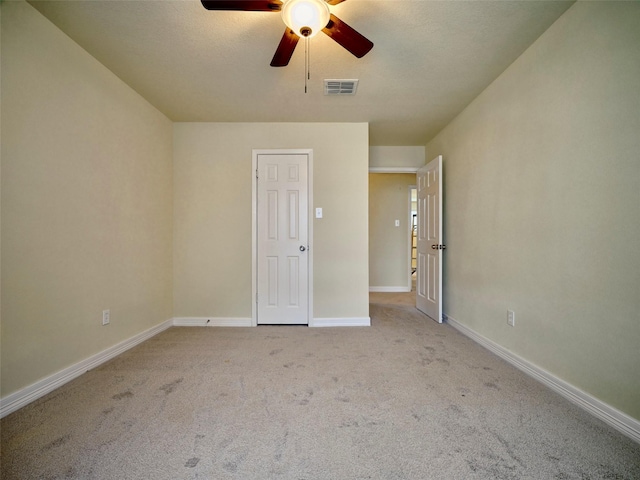 carpeted spare room with ceiling fan