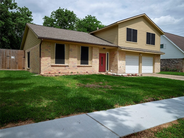 split level home featuring a front yard and a garage