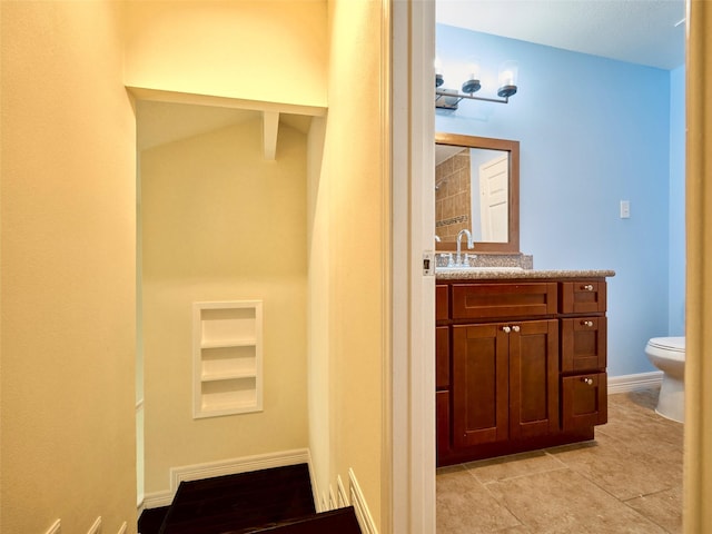 bathroom with toilet and vanity