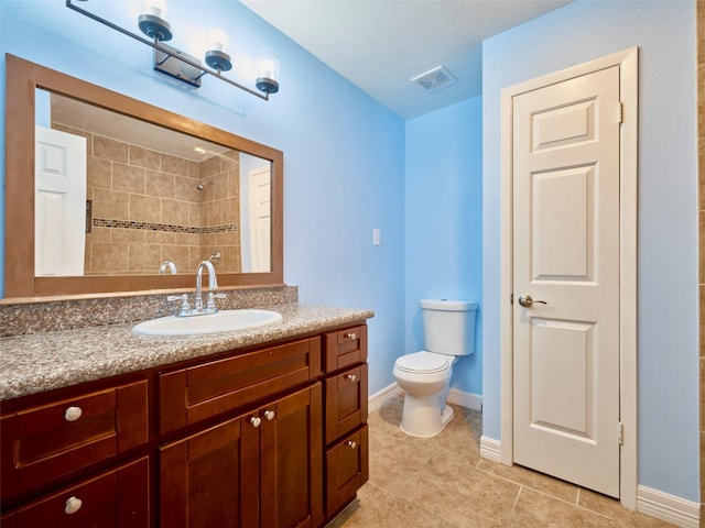 bathroom featuring toilet, a textured ceiling, tile patterned floors, and vanity