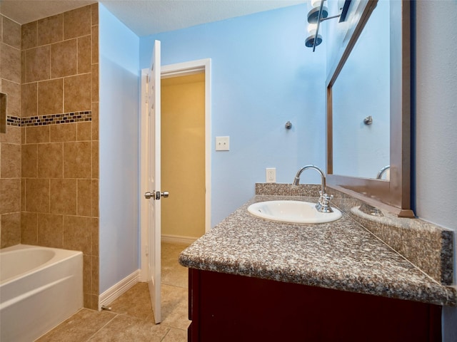 bathroom with a textured ceiling, tile patterned flooring, and vanity