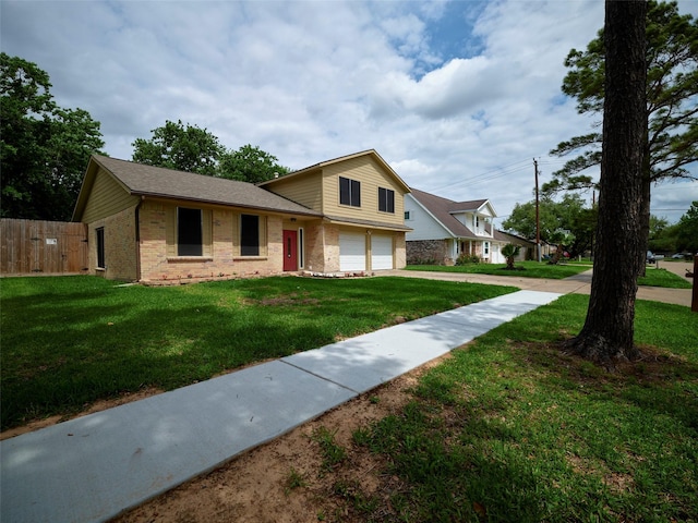 view of front of property featuring a garage and a front lawn