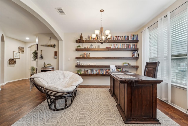 office featuring light hardwood / wood-style floors and an inviting chandelier