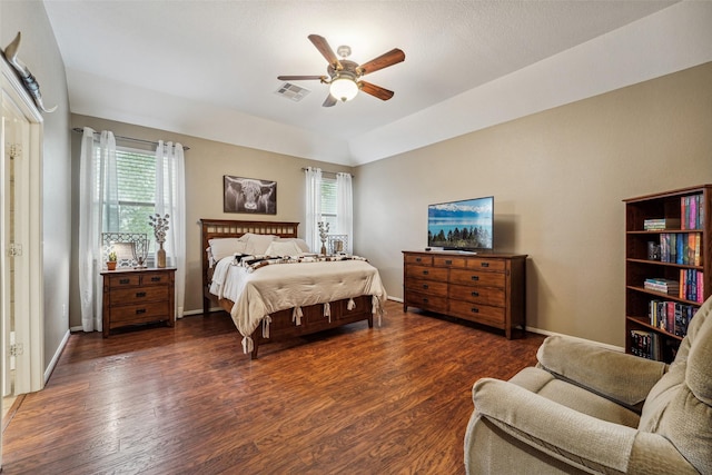 bedroom featuring ceiling fan, dark hardwood / wood-style floors, and multiple windows