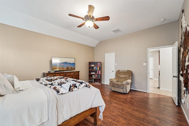 bedroom featuring ceiling fan, dark hardwood / wood-style flooring, and lofted ceiling