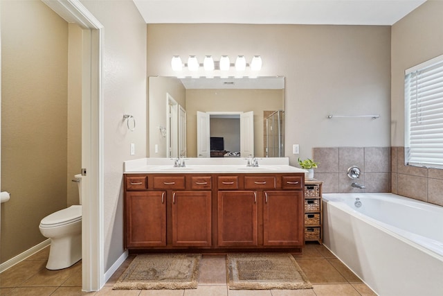 full bathroom featuring toilet, vanity, plus walk in shower, and tile patterned flooring