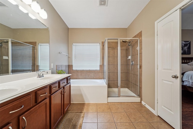 bathroom with shower with separate bathtub, tile patterned floors, and vanity