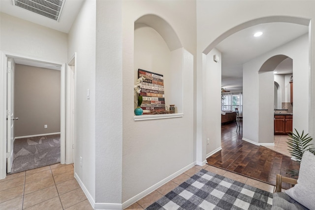 hall featuring light tile patterned floors