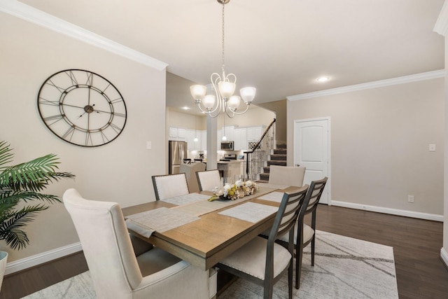 dining area with dark wood-type flooring, crown molding, and an inviting chandelier