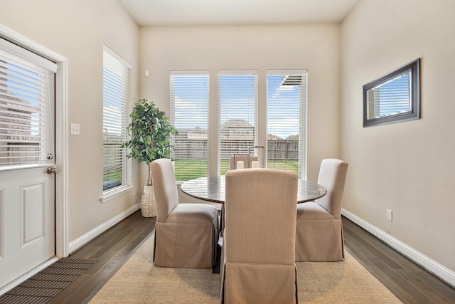 dining area with dark hardwood / wood-style flooring