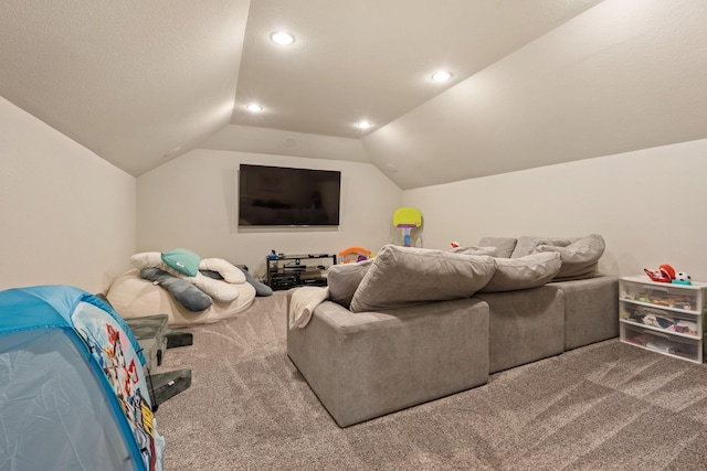 carpeted cinema room featuring vaulted ceiling