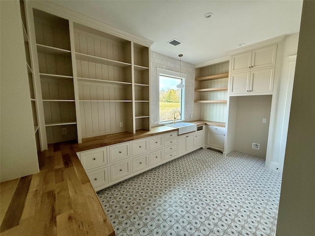 unfurnished office featuring sink and crown molding