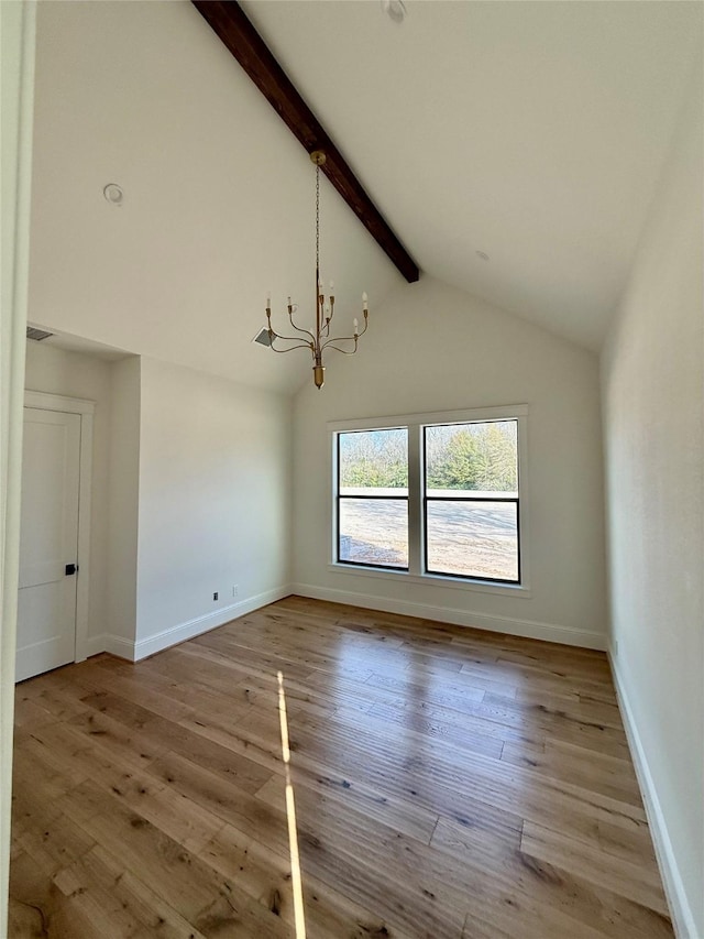 spare room featuring light hardwood / wood-style flooring, vaulted ceiling with beams, and a notable chandelier