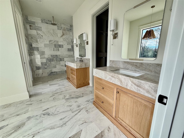 bathroom with vanity and tiled shower