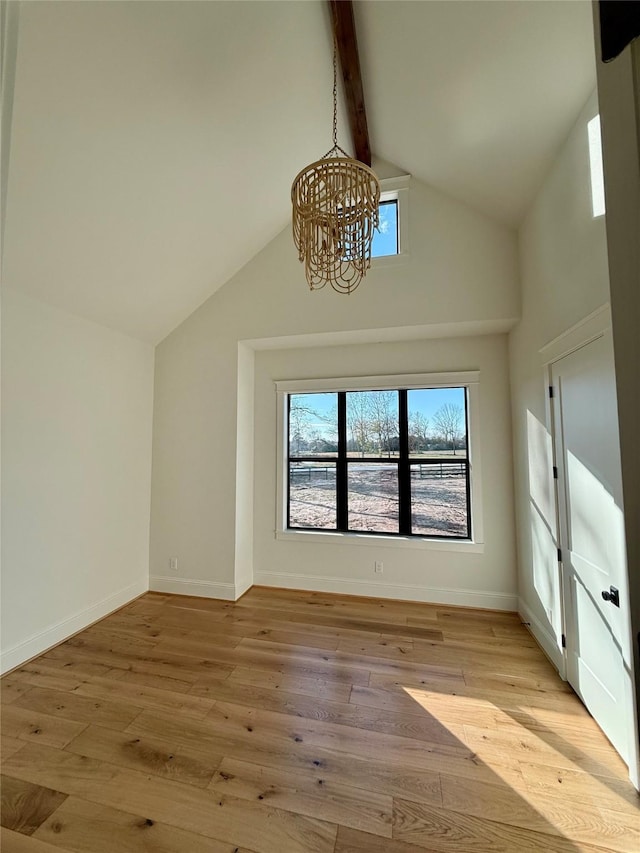 interior space with vaulted ceiling with beams, a chandelier, and light hardwood / wood-style flooring