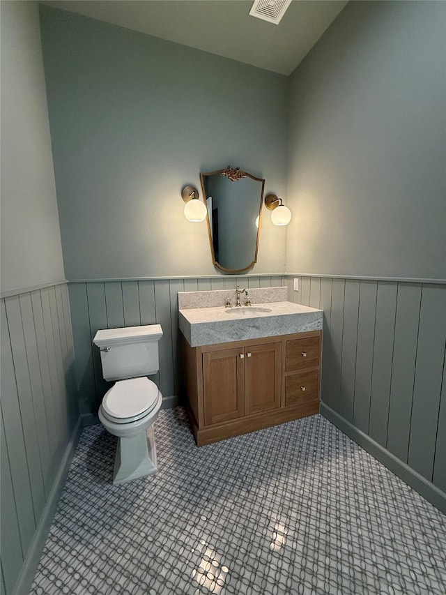 bathroom with vanity, tile patterned floors, and toilet