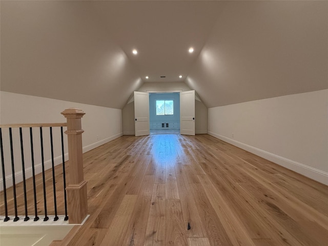 bonus room with lofted ceiling and light hardwood / wood-style flooring