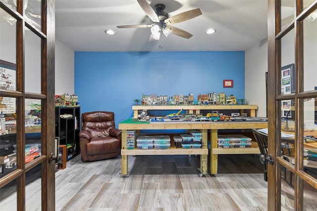 rec room with wood-type flooring and ceiling fan