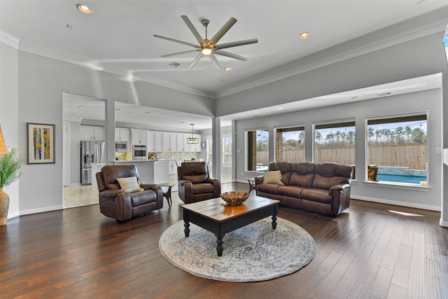 living room with crown molding and dark hardwood / wood-style floors