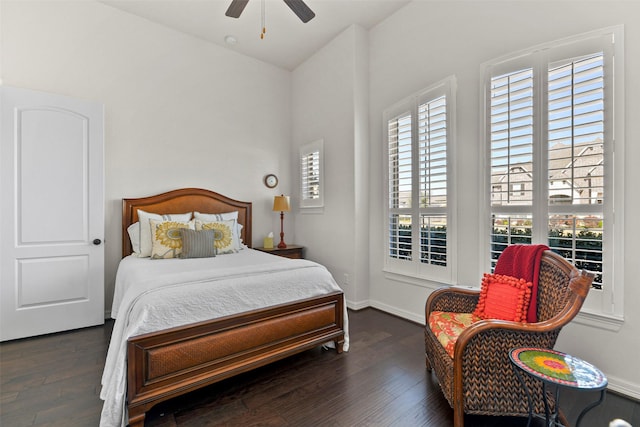 bedroom with dark hardwood / wood-style floors and ceiling fan