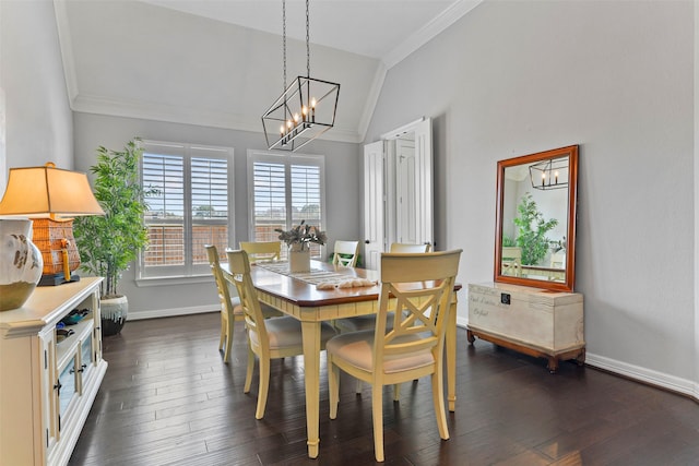 dining space with vaulted ceiling, ornamental molding, an inviting chandelier, and dark hardwood / wood-style flooring