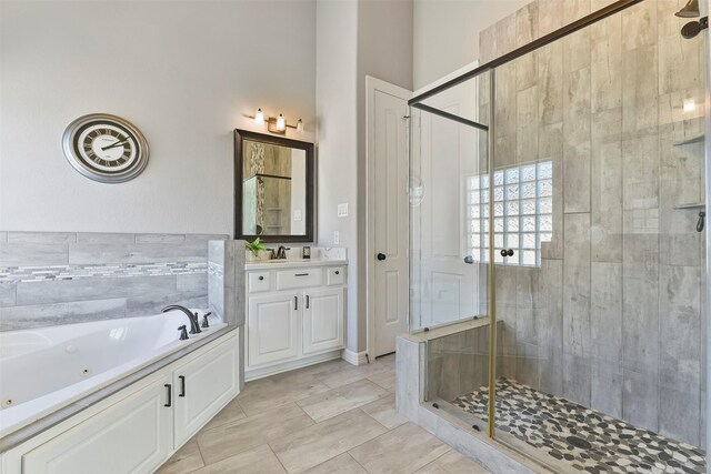 bathroom featuring vanity and shower with separate bathtub