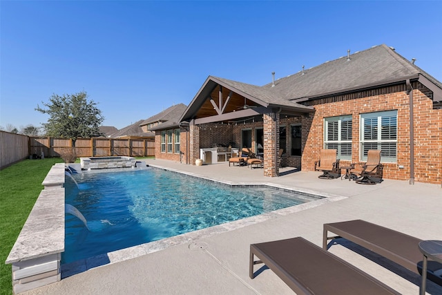 view of swimming pool featuring pool water feature, an outdoor fire pit, an in ground hot tub, and a patio