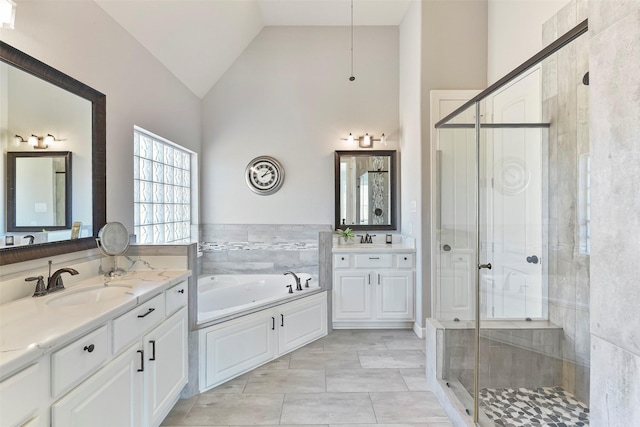 bathroom featuring plus walk in shower, high vaulted ceiling, vanity, and tile patterned floors