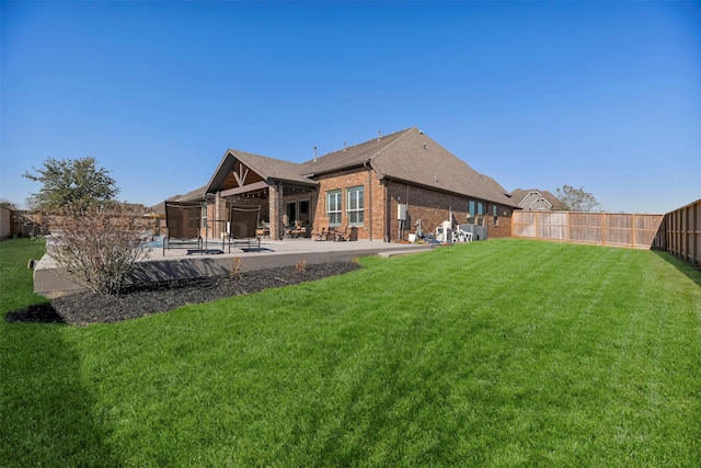 back of house featuring a yard and a patio area