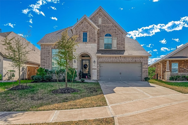 view of front of property featuring a garage and a front lawn