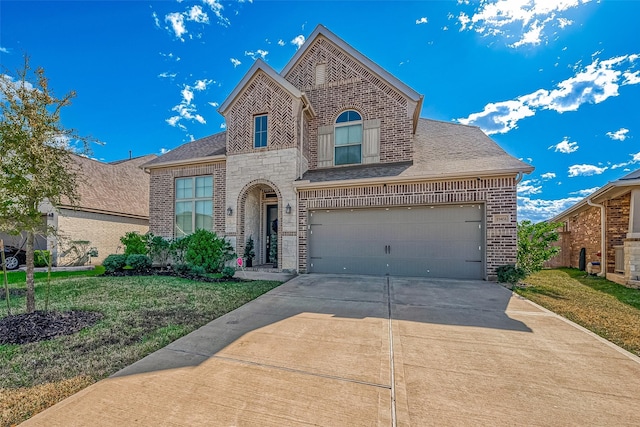 view of front of house featuring a front yard and a garage