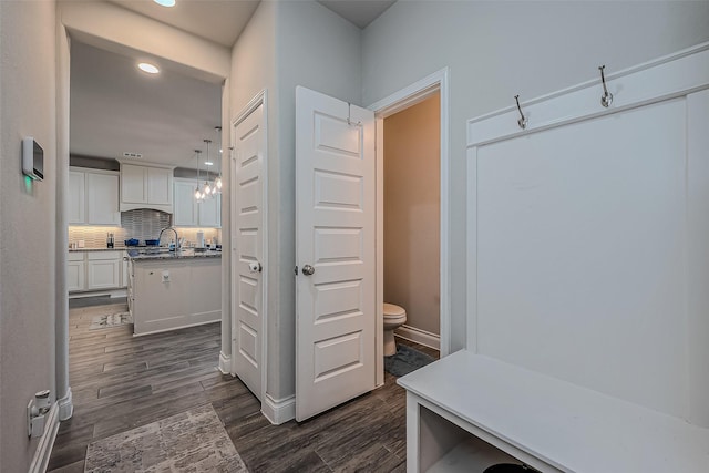 mudroom with dark hardwood / wood-style floors and sink