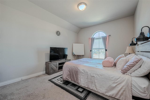 bedroom featuring vaulted ceiling and light carpet