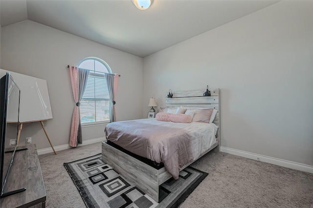 bedroom featuring light carpet and vaulted ceiling