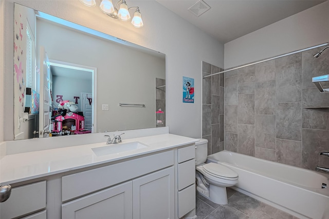 full bathroom featuring toilet, tile patterned flooring, tiled shower / bath combo, and vanity