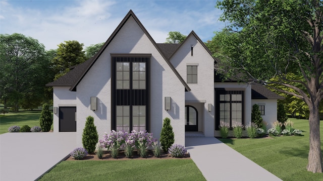 view of front of home with a front yard and a garage