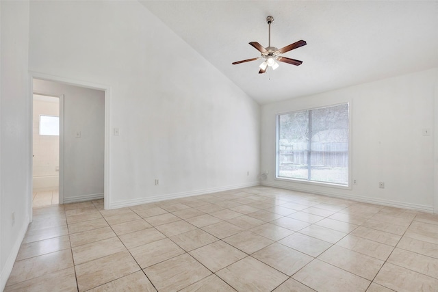 tiled empty room with ceiling fan and high vaulted ceiling