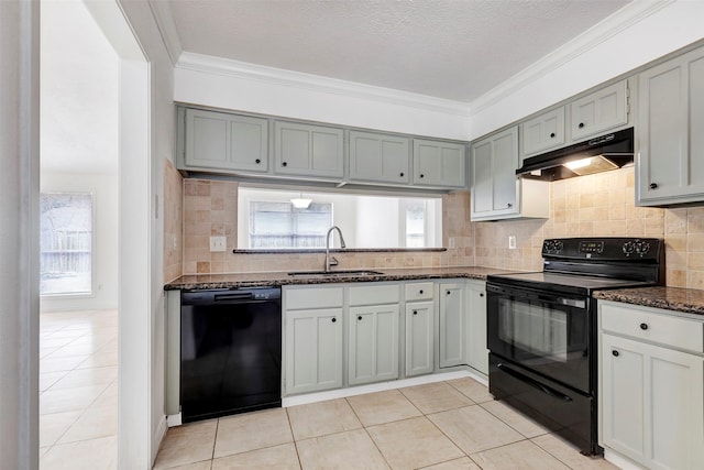 kitchen featuring light tile patterned flooring, decorative backsplash, sink, and black appliances