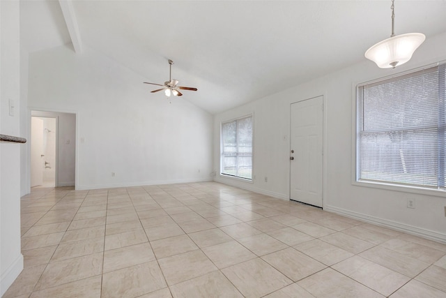 foyer featuring ceiling fan, a healthy amount of sunlight, and vaulted ceiling with beams