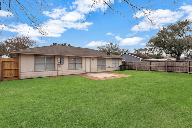 back of property with a lawn, cooling unit, and a patio