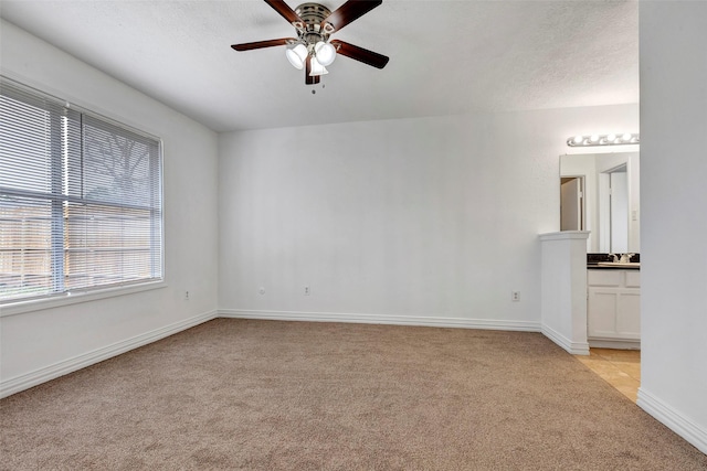 carpeted empty room featuring ceiling fan