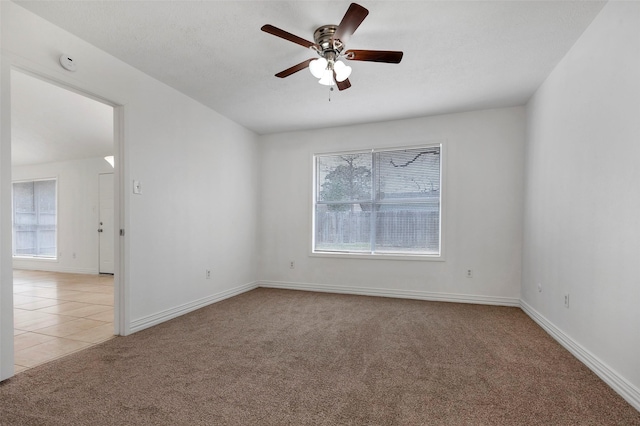 unfurnished room featuring light carpet and ceiling fan